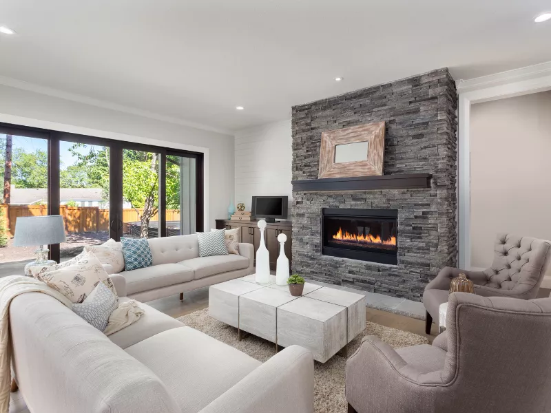 Modern kitchen renovation UK featuring warm neutral cabinets and natural wood finishes
